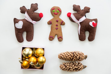 Flat view of cute Christmas decoration, cones, box of glass balls, ginger man, Rudolph the Red...