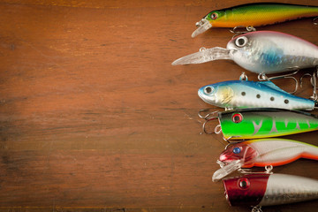 Fototapeta na wymiar Set of Fishing Lure on wood table with copy space