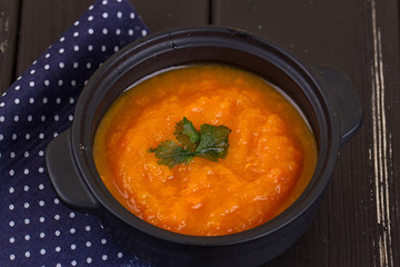 pumpkin soup in a small black pot