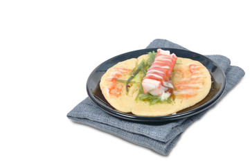 Single imitation crabmeat pancake on gray napery.