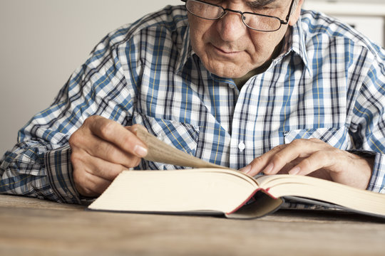 Man reading book on table