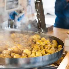 New potatoes fried in a pan with Italian recipe: potatoes salent
