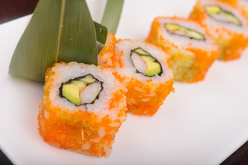 Sushi rolls on a white plate