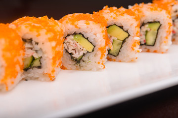 Sushi rolls on a white plate