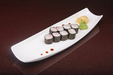Obraz na płótnie Canvas Sushi rolls on a white plate