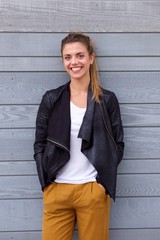 Beautiful smiling woman in ponytail wearing leather jacket