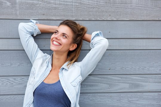 Cheerful Woman Standing With Hands Behind Head