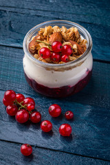 Granola breakfast decorated with berries on the navy-blue background with kitchen towel