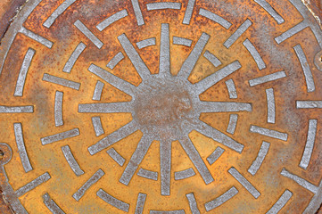 Rusty manhole cover on street, drain cover top view.