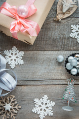 Preparation for Christmas holiday. Christmas Still life of gift box and decor. Top view and copyspace. Flat lay. Creative diy hobby background. Homemade wrapped christmas present on wooden surface.