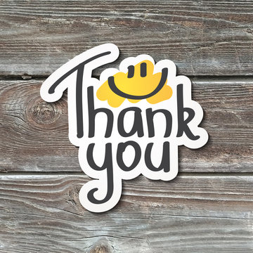 thank you, lettering with smile, handwritten text, paper sticker on realistic wood texture
