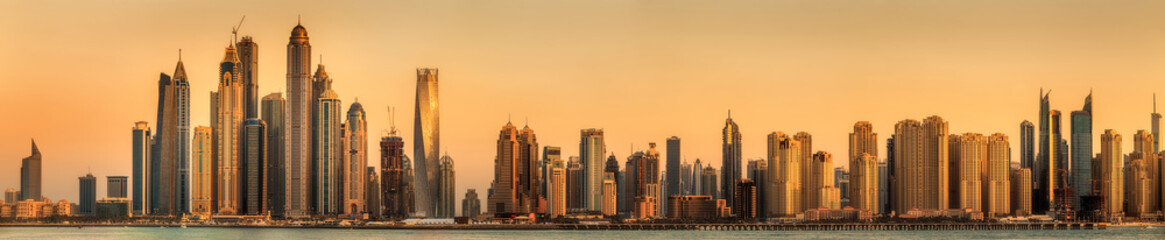Fototapeta na wymiar Panoramic view of Dubai Marina bay with cloudy sky on sunset, Dubai, UAE.
