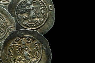 Ancient round silver coins isolated on black