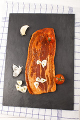 marinated pork bacon with garlic on slate