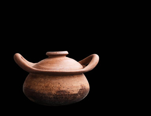 clay pot on black background.