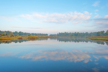 Shore of a lake at sunrise in autumn