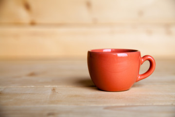 Red coffee cup on wooden table