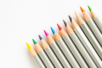 Naklejka premium Colored pencils on white background