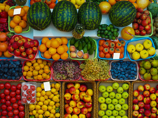 A wide range of fruits and vegetables on the market. View from the top of the counter