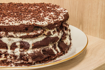Сhocolate cake is soaked in sour cream and decorated with chocolate shavings