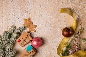 Christmas decoration background: Pine and holly branches, handmade gifts with labels, cardboard...