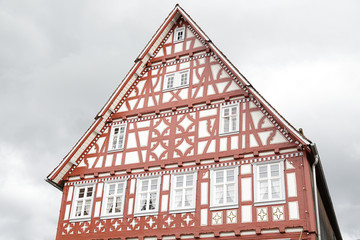 Facade of one traditional half-timbered house in a rainy day located in Dornstetten, Black Forest,...