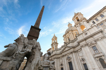 Fototapeta na wymiar The fountain of the four Rivers with Egyptian obelisk and Sant Agnese church in Piazza Navona, Rome, Italy
