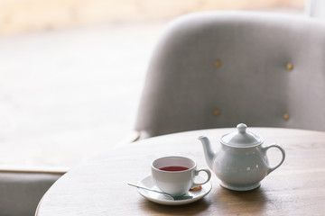 Still life details, cup of tea on a coffee table in living room