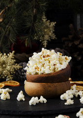 popcorn in a wooden plate on the background of Christmas