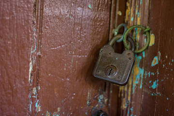 Old rusty lock on the wooden gate