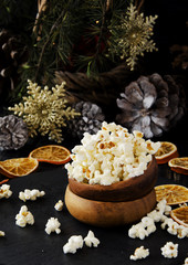 popcorn in a wooden plate on the background of Christmas