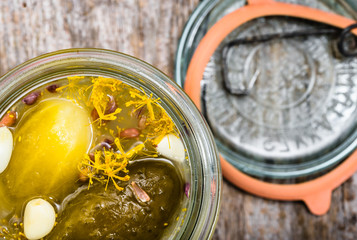 Macro of gherkin in jar. Homemade pickle preserves, top view.