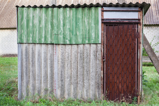 Old weathered barn with metal door.