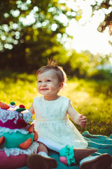 amazing  little girl sitting near colored cake