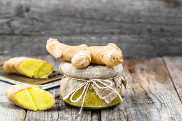 Grated ginger in a glass jar, seasoning ingredients, medicinal spice for self treatment
