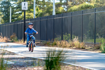 Happy boy riding his bicycle on bike lane
