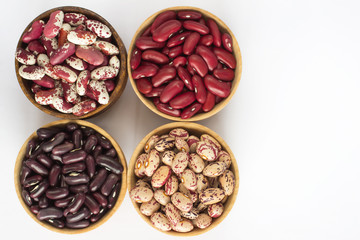 Four kinds of beans on white background. Top view.