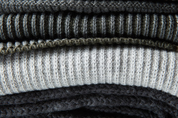 Stack of gray woolen knitted sweaters