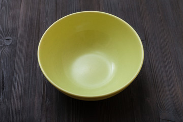 green bowl on dark brown board