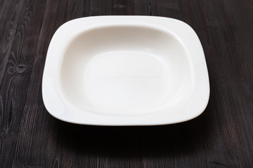 white bowl on dark brown board