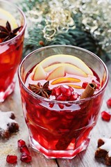 Mulled wine,punch,bowl oder spiced tea : winter traditional warming drinks with spicy,citrus fruits and pomegranate . Rustic style.Selective focus