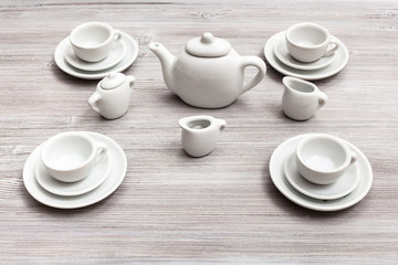 cups with saucers and tea set on gray brown table