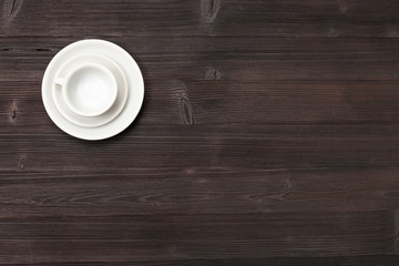 top view of cup with saucers on dark brown table