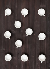top view of many white cups on dark brown table