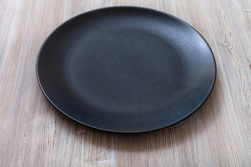 black plate on gray brown table