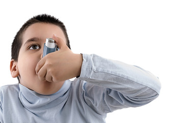 Cute little boy using inhaler for asthma isolated on white background.    