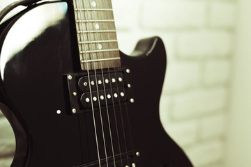Electric guitar body and neck detail on wooden background