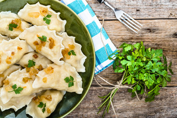 Homemade dumplings with fried onion on plate, top view, cooking concept