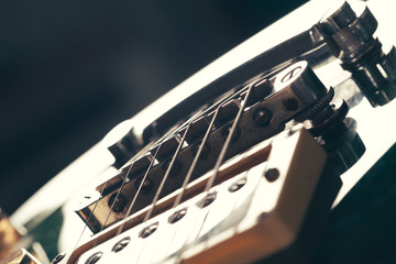 Electric guitar body and neck detail on wooden background