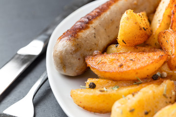 potatoe wedges and a sausage